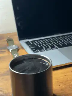 Coffee cup on desk with laptop
