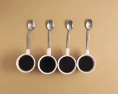 Four coffee cups with spoons