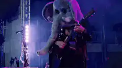 Elephant mascot plays guitar on stage