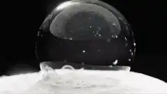 Ice crystals forming on a water droplet