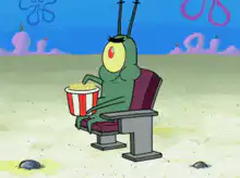 Plankton eating popcorn in theater seat