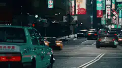 Orange sports car drifting on city street