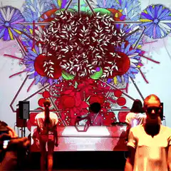 DJ performing on stage with psychedelic visuals