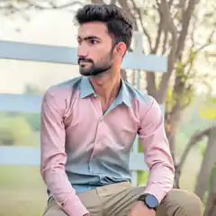 Man in two-tone shirt sitting outside