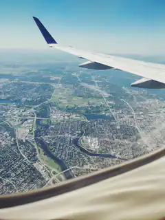 airplane wing over city from window