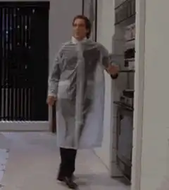 Christian Bale in plastic raincoat