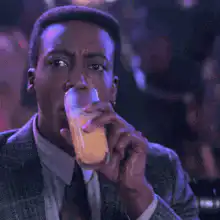 Eddie Murphy drinking juice and looking shocked