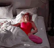 Woman in bed facepalms