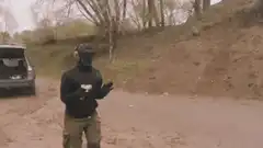 Person shooting pink pistol in dirt