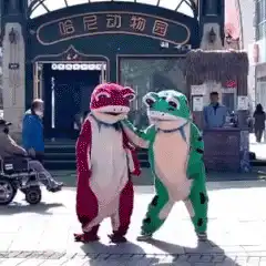 red and green frog mascots dancing