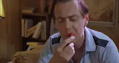 Steve Buscemi applying red lipstick