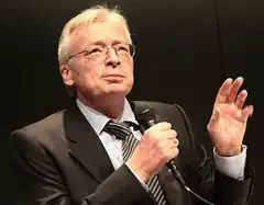 Man in suit speaking into microphone