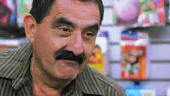 Man squinting and smiling