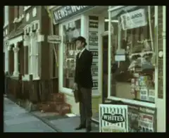 Man walks past newsagent and turns around