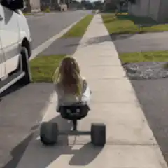 Girl on electric skateboard falls off