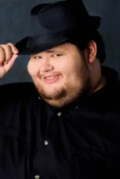 Man tipping black fedora hat