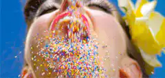 Woman catching sprinkles in mouth