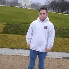 Man in white hoodie dancing outside