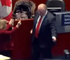 Man in suit dancing in parliament