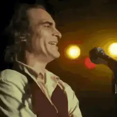 Joaquin Phoenix singing into microphone