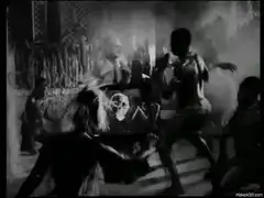 people dancing around a skull