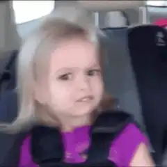 confused little girl in car seat