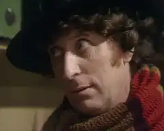 Fourth Doctor raises finger and smiles