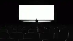 Silhouette of person on stage in empty theater