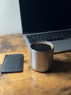 Coffee cup and laptop on desk