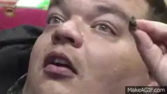 Man holding bug near eye