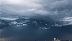 Dark storm clouds rolling over city
