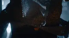 Man lifts chainmail mask