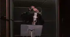 Woman in fur coat singing in recording booth