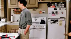 Chandler and Joey hug in the kitchen