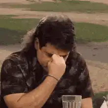Man rubs eyes then makes shaka sign
