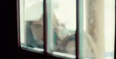 Girl peeking through window with wide eyes
