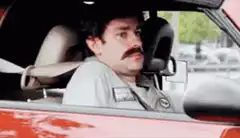 Ron Swanson sinks into car seat