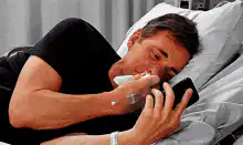 Man coughing in bed