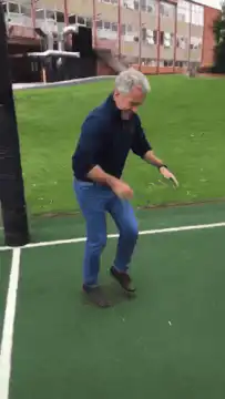 Man doing a silly dance on a sports court