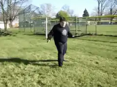 Man dancing with two sticks in park