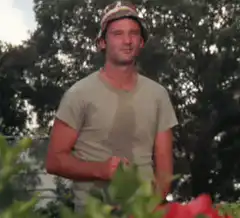 Man in bucket hat smiling outdoors