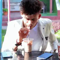 man sipping iced coffee with straw