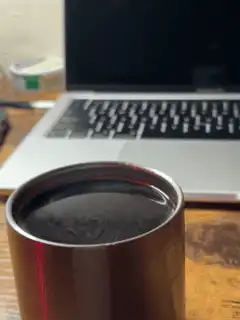 Coffee swirling in a metal cup