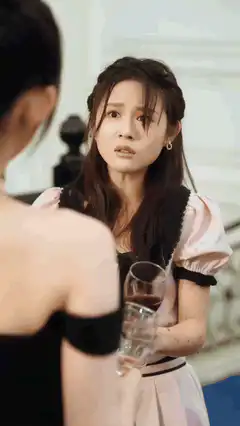 Woman spills wine on another woman