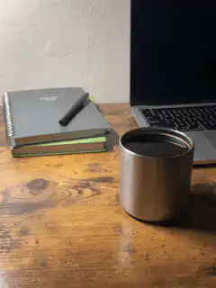 notebook and coffee on desk
