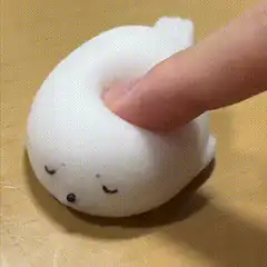 Finger squishing white seal squishy toy