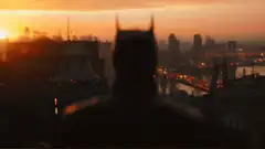 Batman silhouette overlooking city at sunset