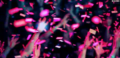 pink confetti falling on raised hands