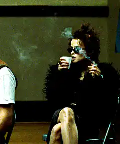 Woman smoking and drinking coffee