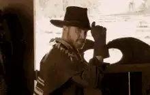 Cowboy turns around and opens saloon doors